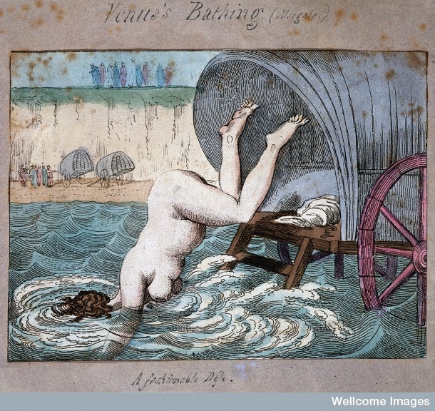 A woman diving off a bathing wagon in to the sea. 