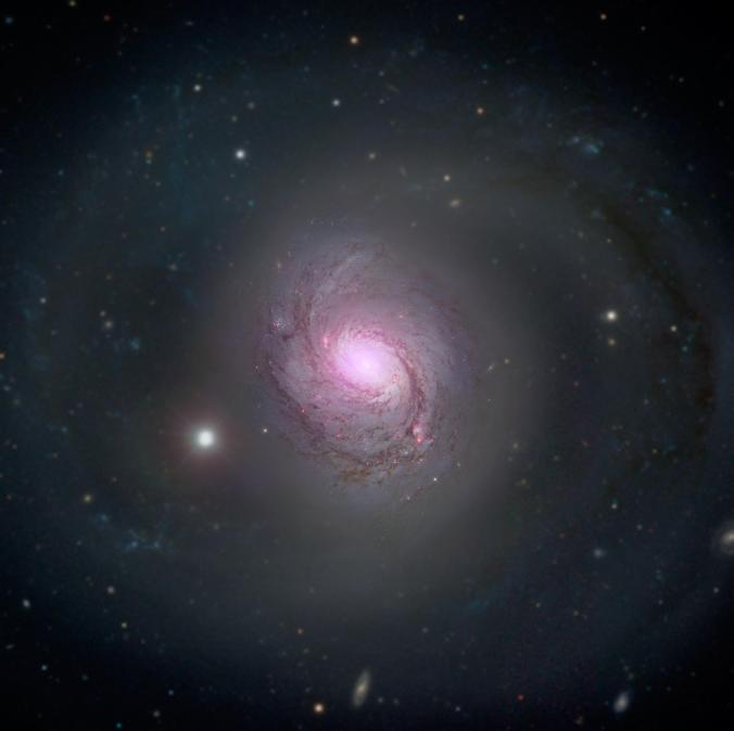 This composite image shows visible light and x-rays coming from Galaxy NGC 1068, located 47 million light-years away. The x-ray light comes from a supermassive black hole (aka a quasar) at the center of the galaxy.